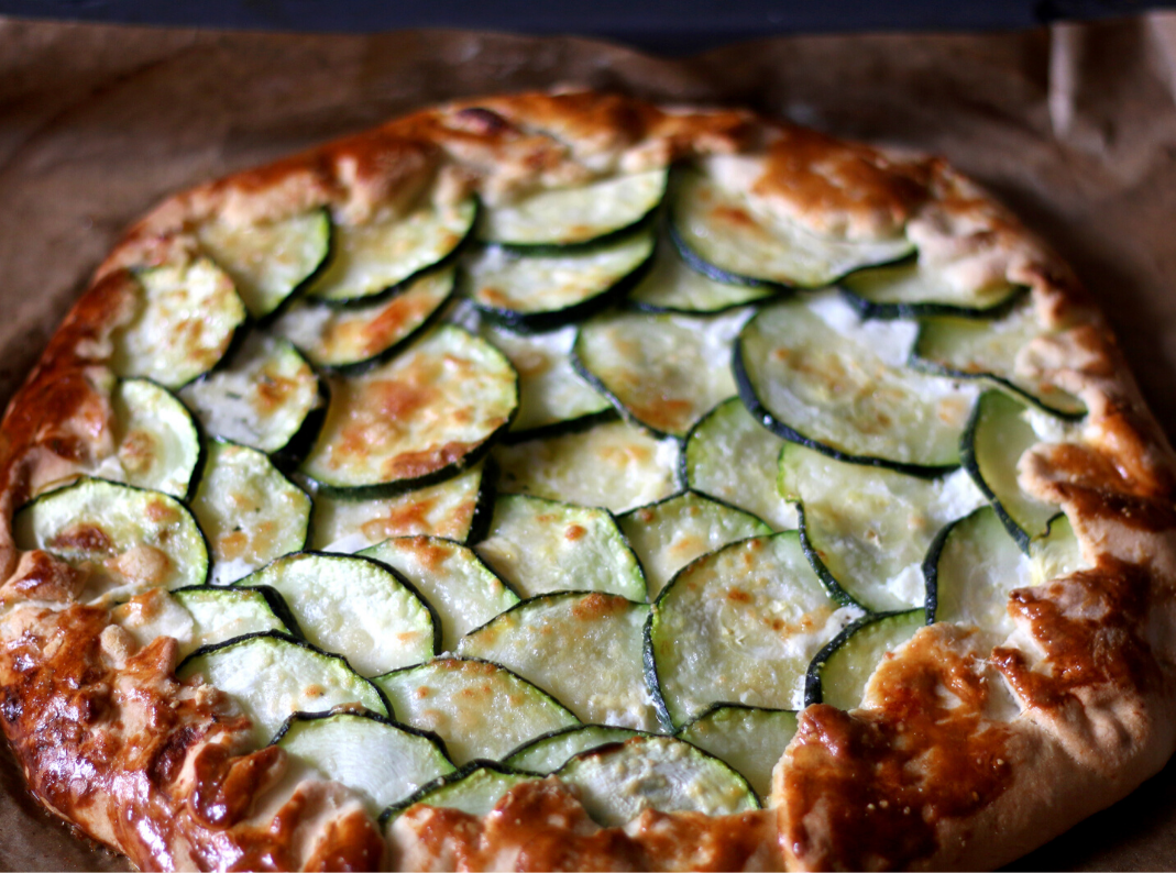 a pizza sitting on top of a wooden cutting board