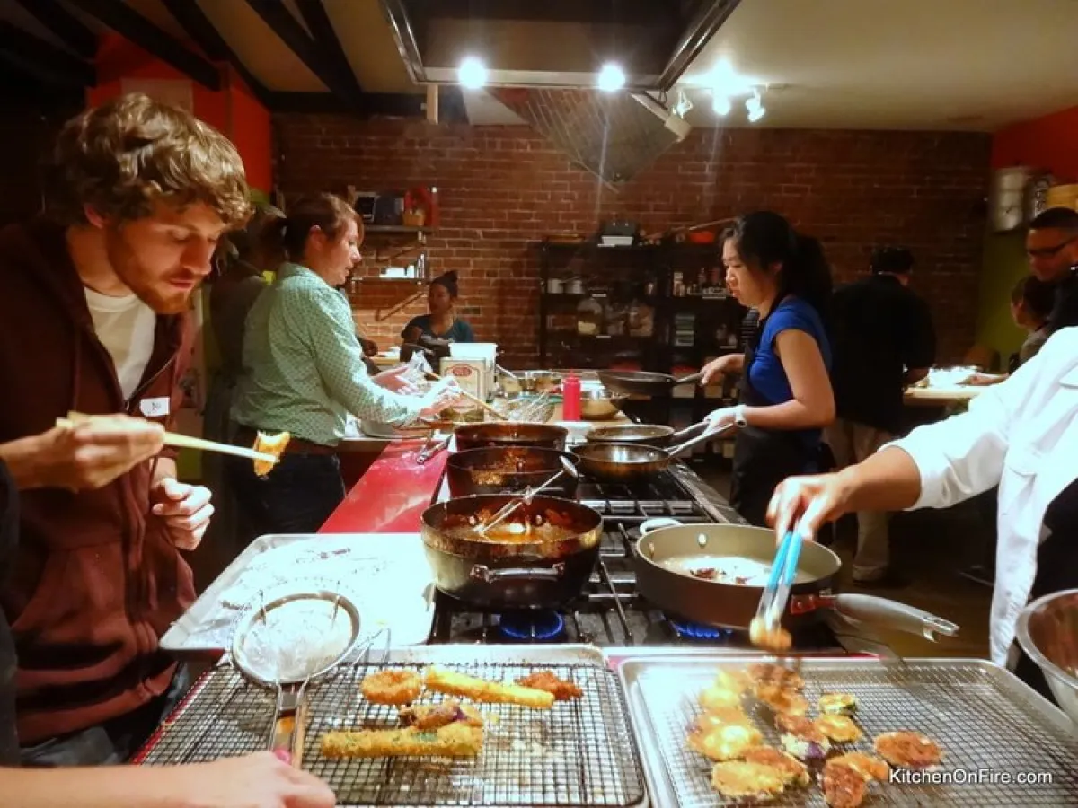 a group of people preparing food at Kitchen on Fire