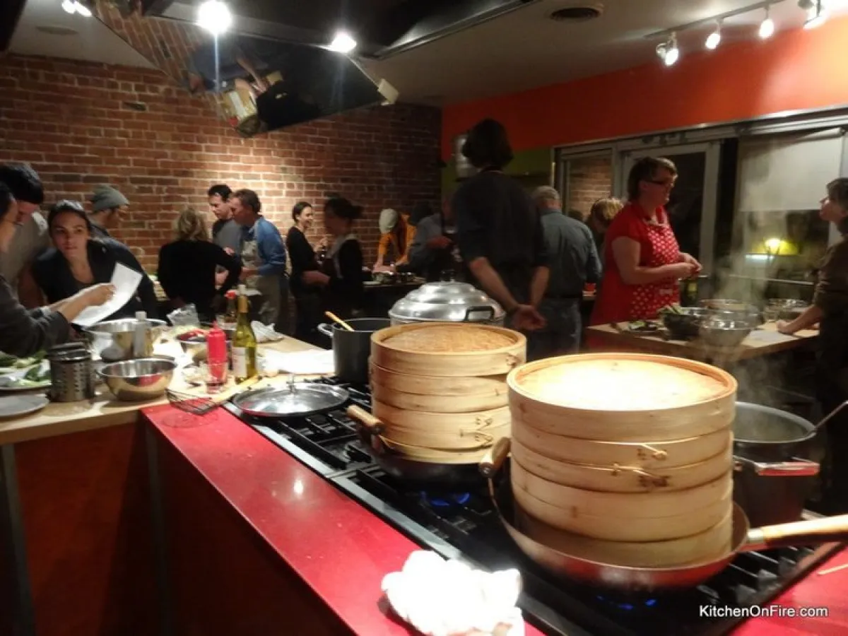a group of people preparing food in a kitchen