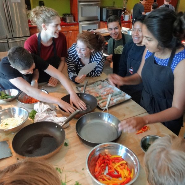 a group of people sitting at a table with food