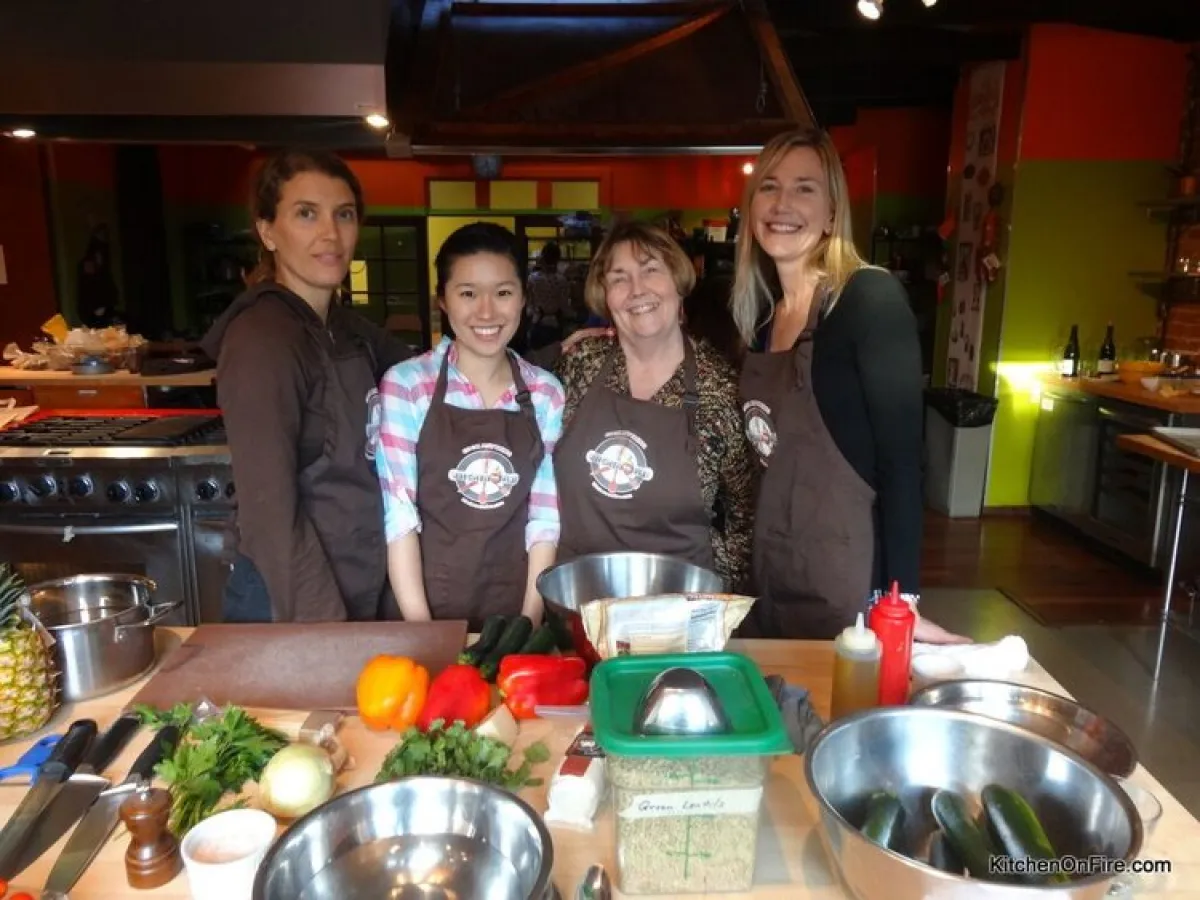 a group of people standing around a table