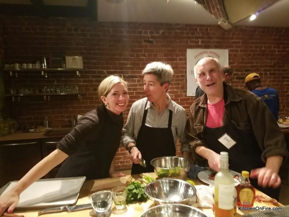 a group of people standing around a table