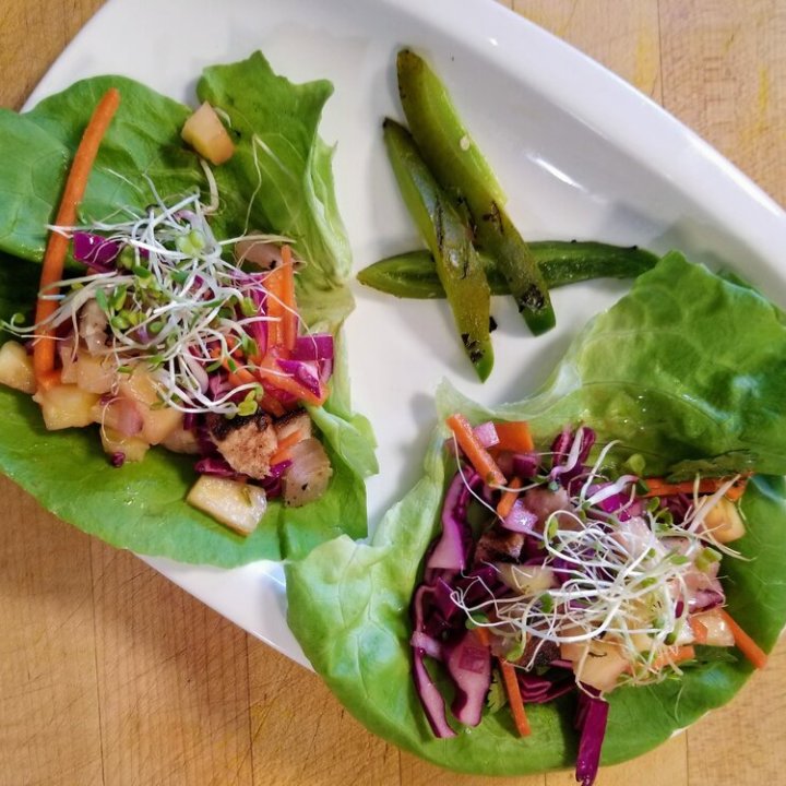a salad sitting on top of a wooden table