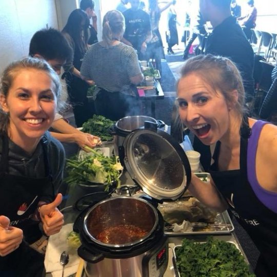 a woman cooking food in a bowl