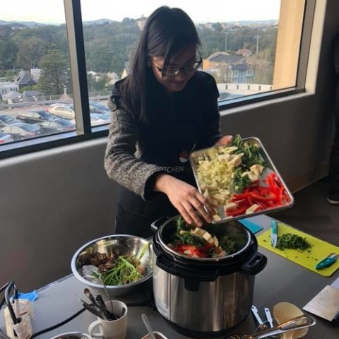a person sitting at a table in front of a window