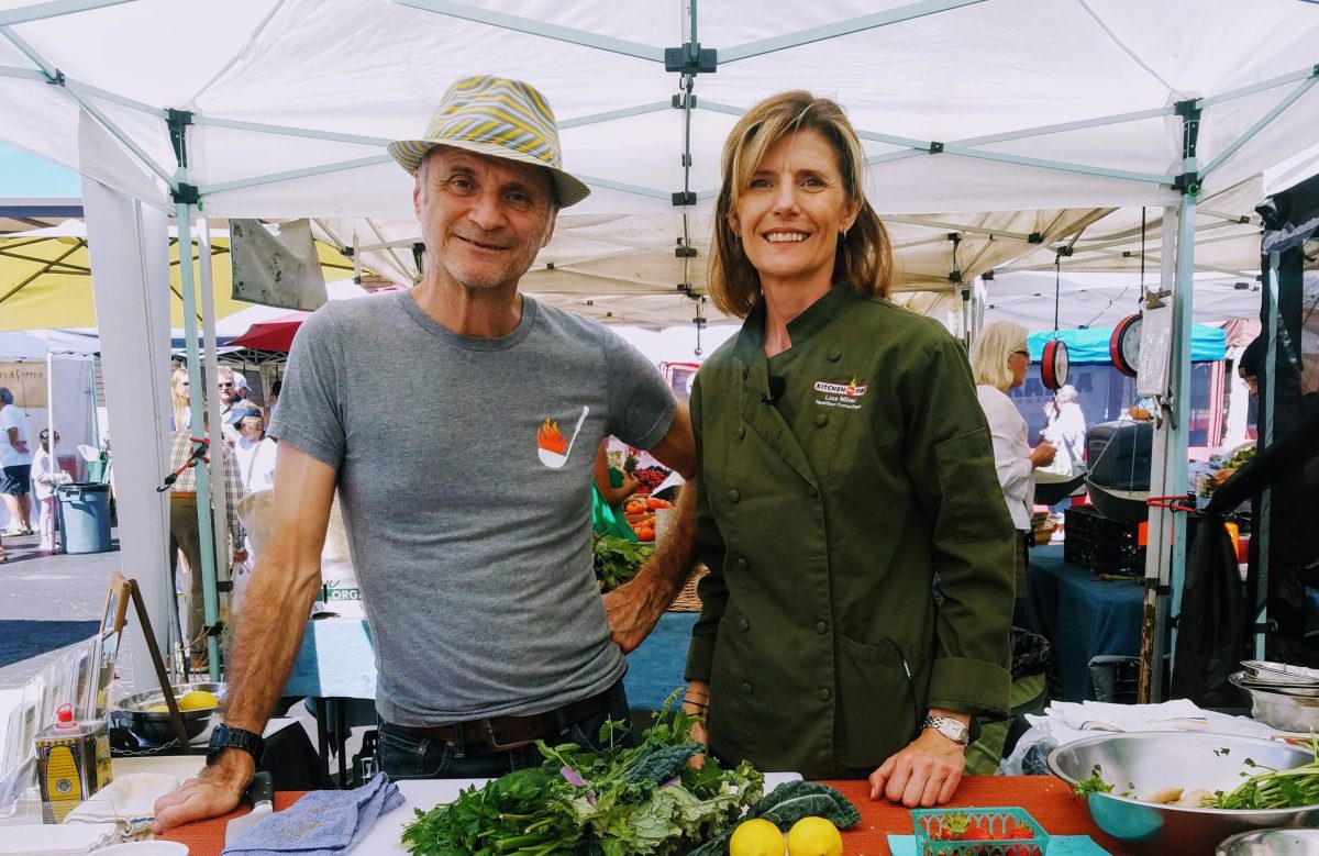 Lisa Olive Farmers’ Market a man standing next to a woman smiling for the camera