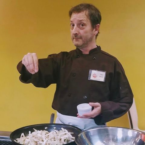 a man standing in front of a plate of food