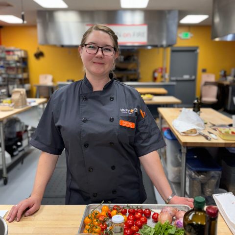 a person standing in a kitchen preparing food